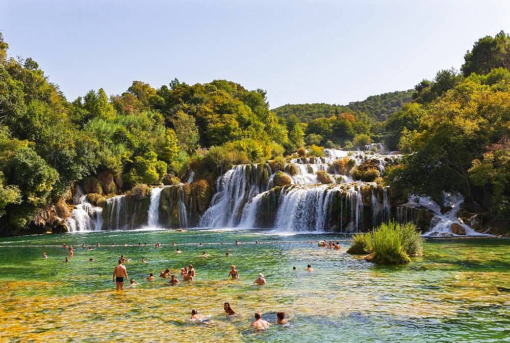 Tourists bathing at the Skradinski Buk waterfall, Krka National Park, Sibenik-Knees Region, Dalmatia, Croatia, Europe