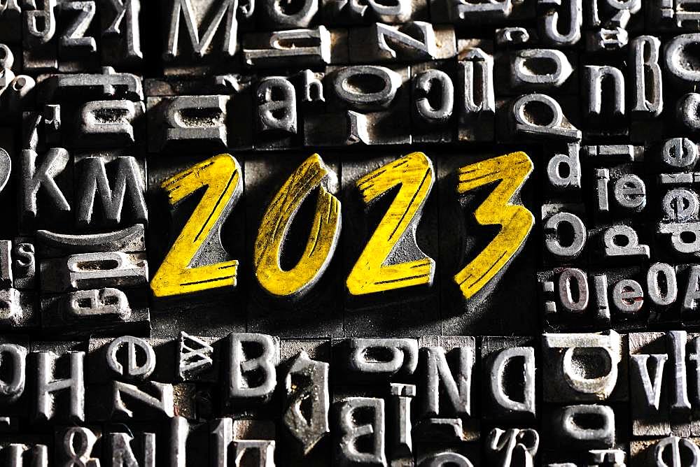 Old lead letters with golden writing show the word 2023, Germany, Europe