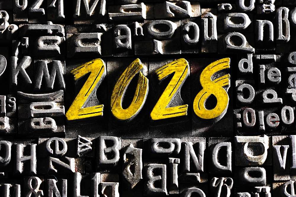 Old lead letters with golden writing show the word 2028, Germany, Europe