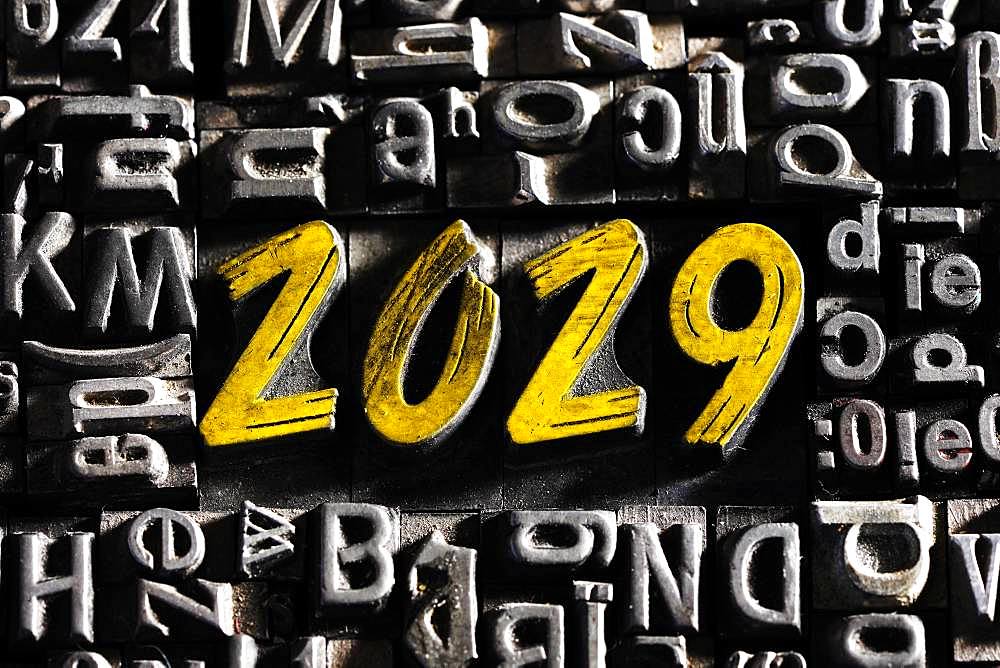 Old lead letters with golden writing show the word 2029, Germany, Europe