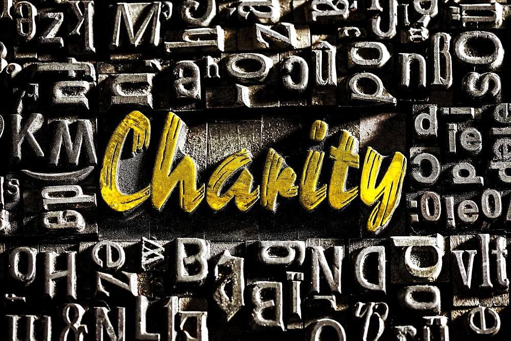 Old lead letters with golden writing show the word Charity, Germany, Europe