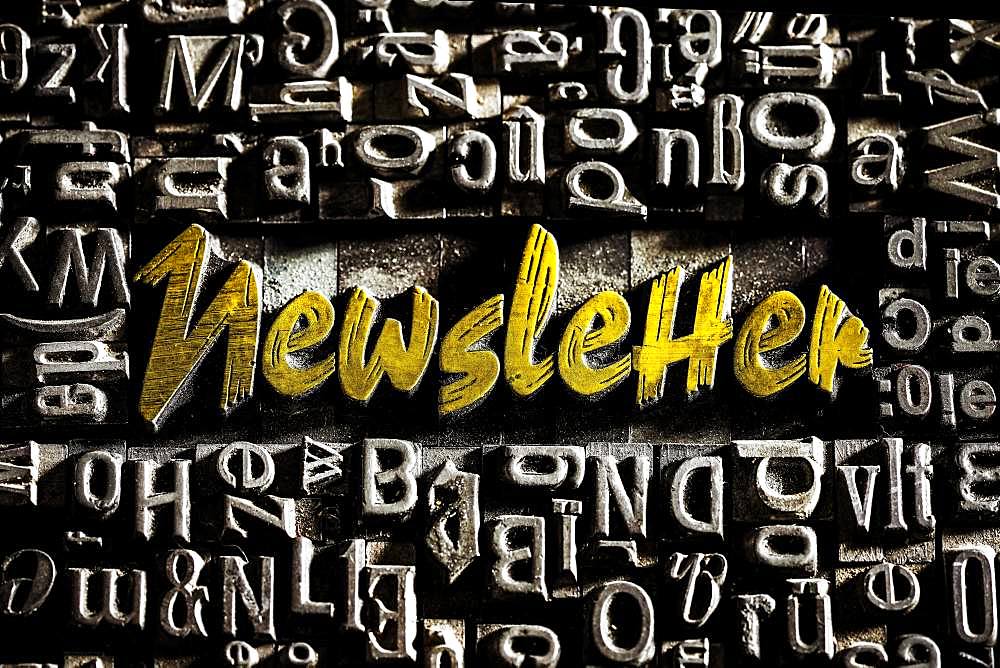 Old lead letters with golden writing show the word Newsletter, Germany, Europe