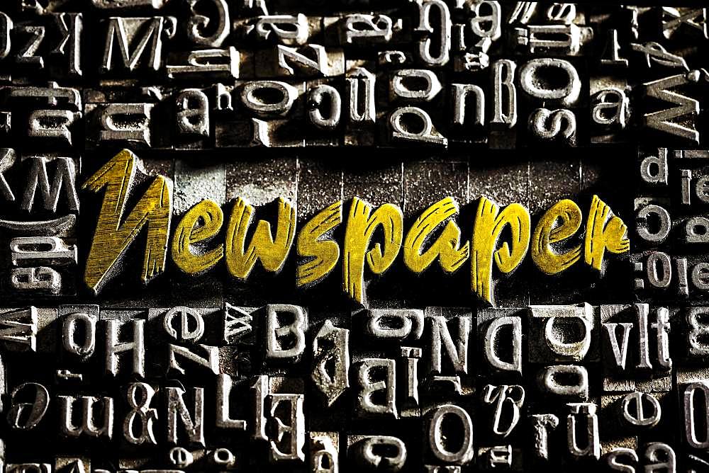 Old lead letters with golden writing show the word Newspaper, Germany, Europe