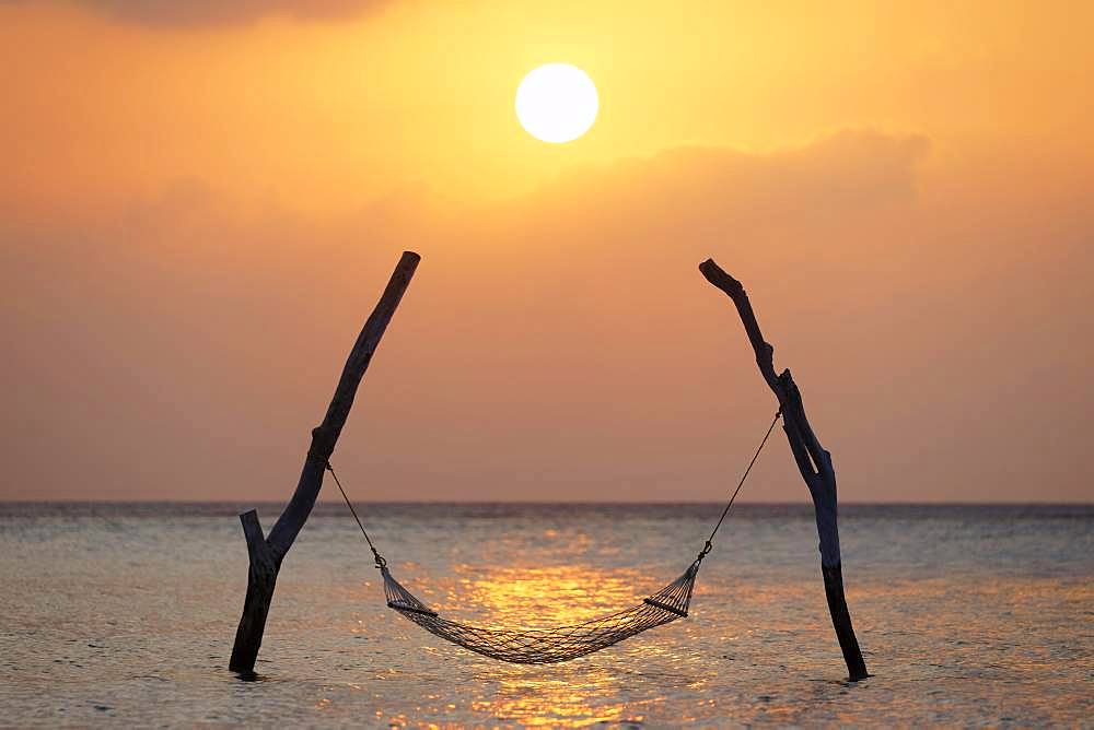 Sunset, Hammock on stilts over the sea, Indian Ocean, symbol for relaxation, recreation, vacation, Summer Island, North Male Atoll, Maldives, Asia