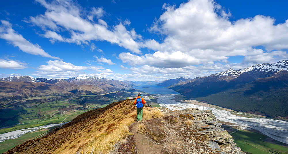 Hiker on the summit of Mount Alfred, views of Lake Wakatipu and mountain scenery, Glenorchy near Queenstown, Southern Alps, Otago, South Island, New Zealand, Oceania