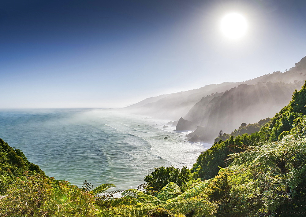 View from the coastal road, unspoiled rocky coast with sea spray, West Coast, Punakaiki, West Coast Region, New Zealand, Oceania