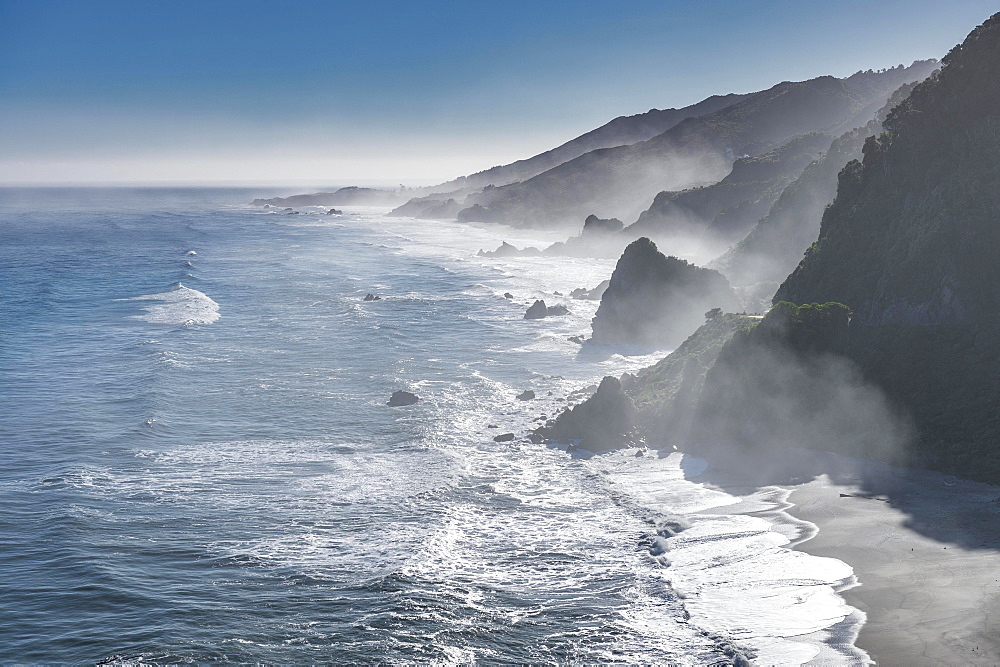 View from the coastal road, unspoiled rocky coast with sea spray, West Coast, Punakaiki, West Coast Region, New Zealand, Oceania