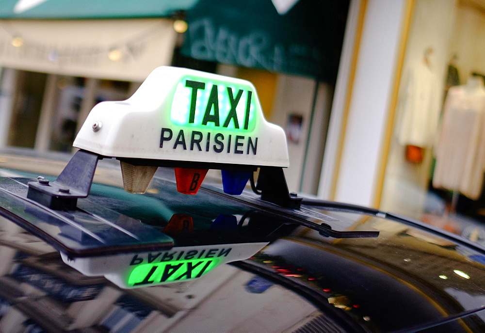 Sign of a Parisian taxi reflected in the roof, Paris, France, Europe