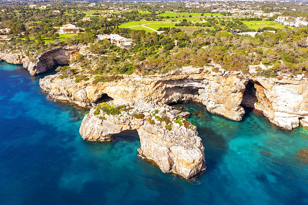 Steep coast with rock gate Es Pontas in the sea, near Cala Santayi, near Santanyi, Migjorn region, drone shot, Majorca, Balearic Islands, Spain, Europe