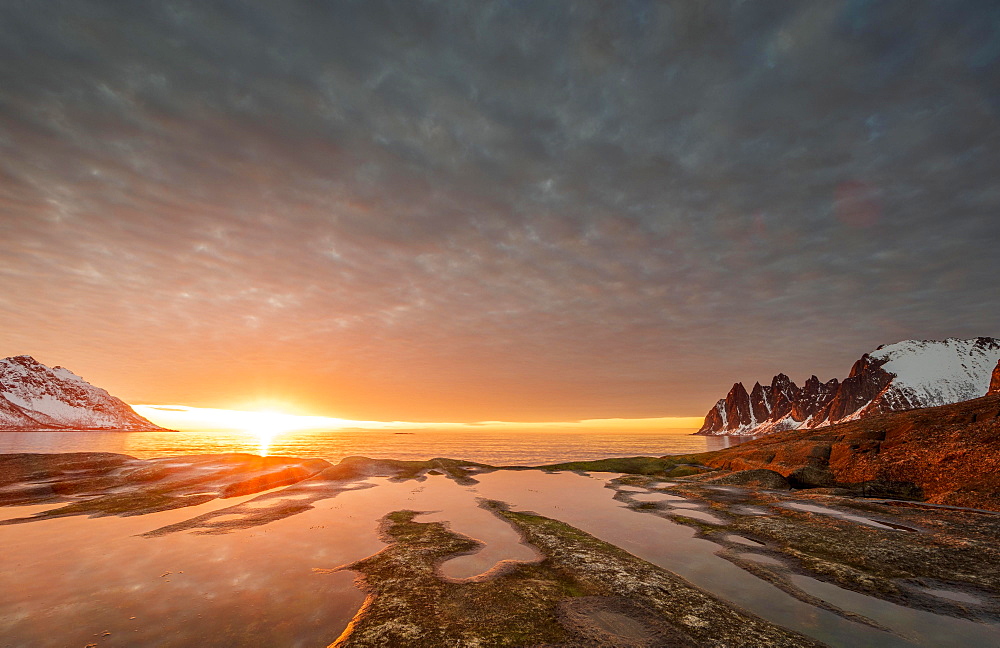 Rocky beach of Tungeneset, rocky peak Devils Teeth, devil's teeth, Okshornan, in warm sunlight, stone fjords, Senja Island, Troms, Norway, Europe