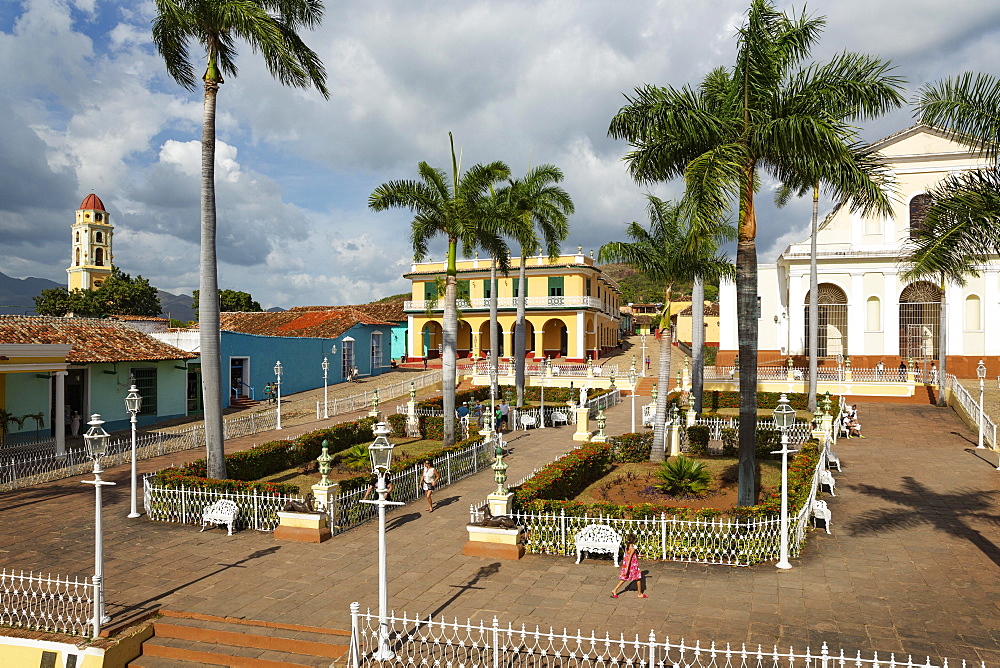 Plaza Mayor with the Museo Romantico on the left and the Iglesia de la Santisima Trinidad on the right, far left the bell tower of the Museo de la Lucha Contra Bandidos, Trinidad, Cuba, Central America