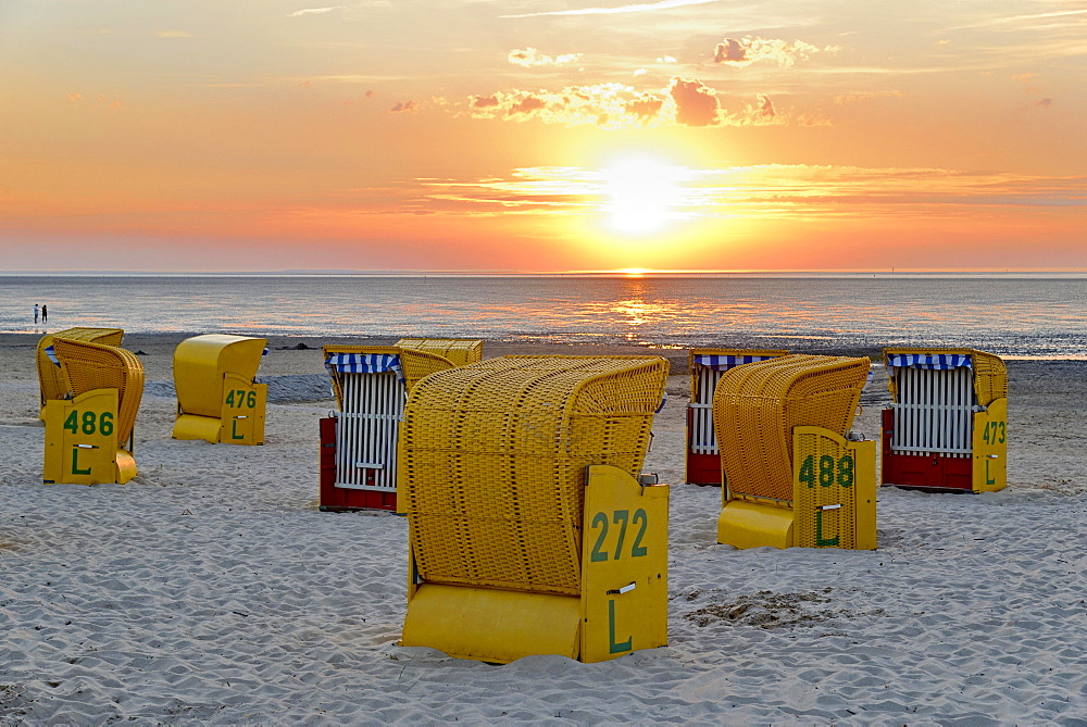 Yellow beach chairs at sunset on the beach of Cuxhaven-Doese, Lower Saxony, Germany, Europe