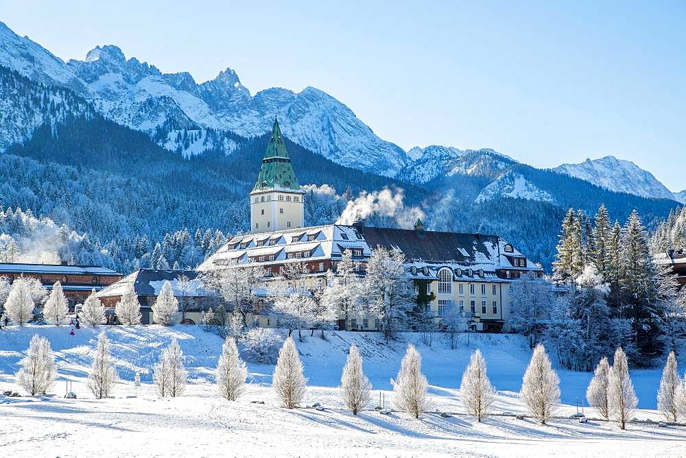 Luxury Hotel Elmau Castle in winter, behind Wetterstein range, Bavarian Oberland, Kruen, Bavaria, Germany, Europe