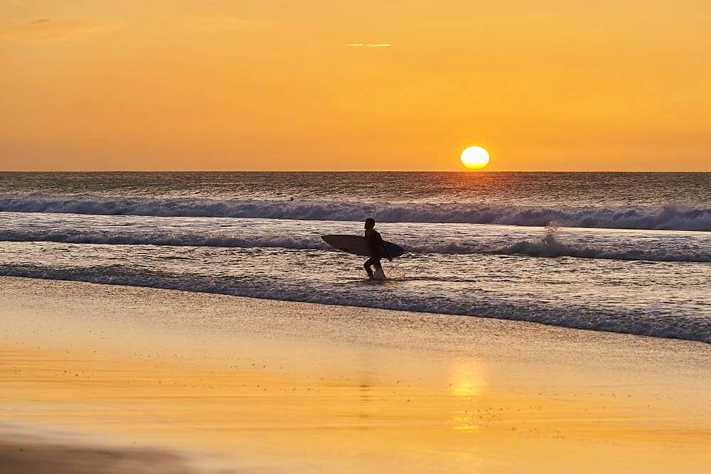 Backlit surfers, sunset beach of Playa del Castillo, Playa del Aljibe de la Cueva, Fuerteventura, Canary Islands, Spain, Europe