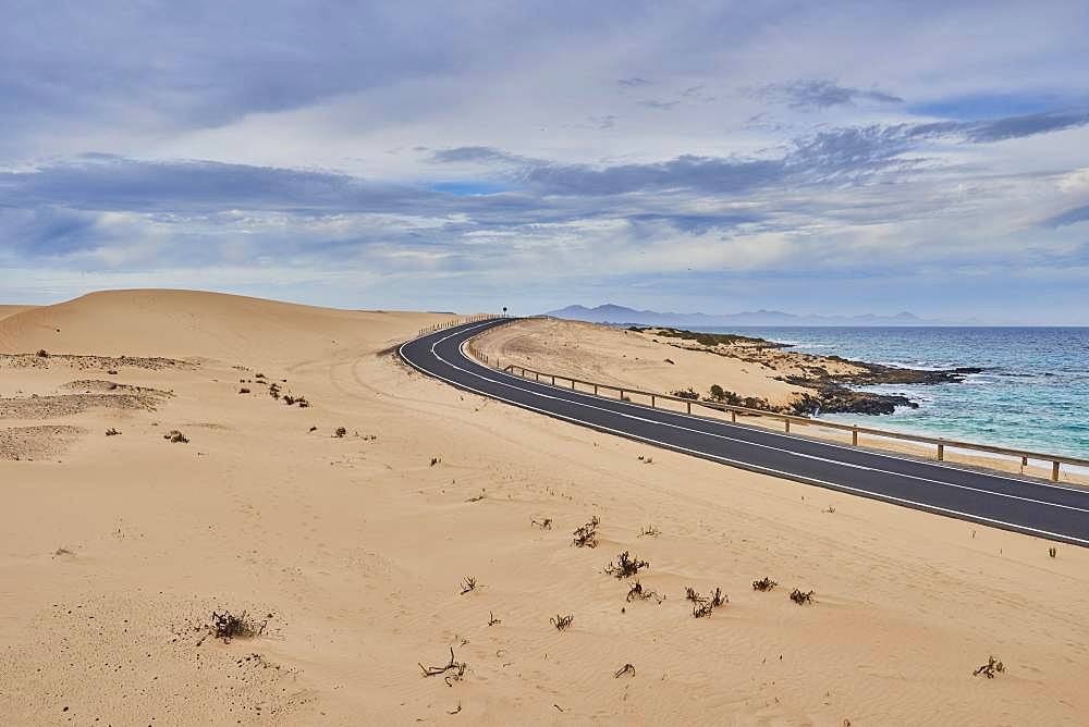 Coastal road through sand dunes, Parque Natural de Corralejo, Fuerteventura, Canary Islands, Spain, Europe