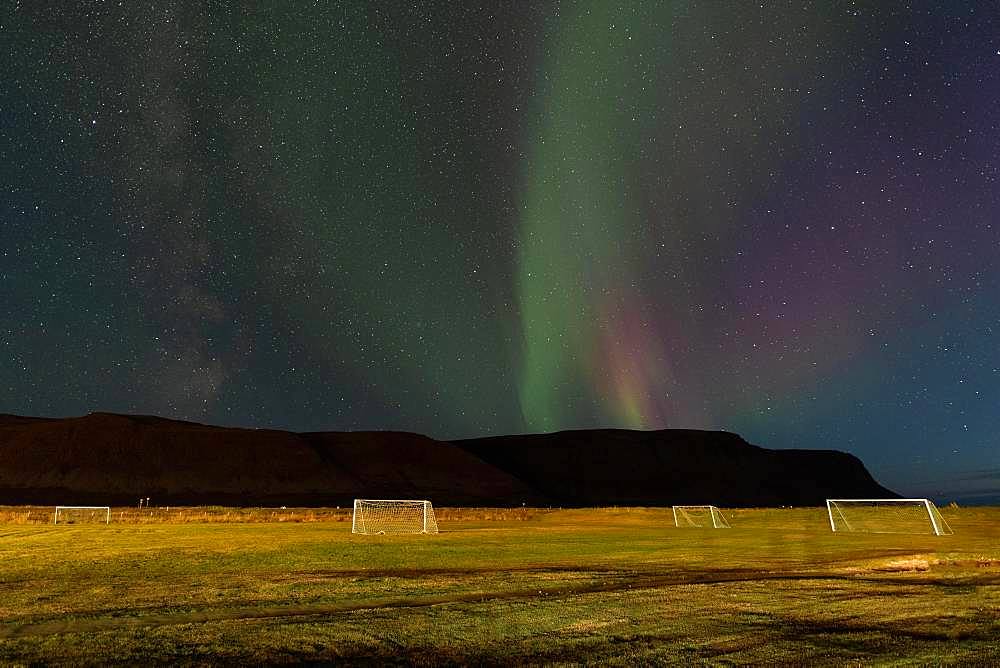 Northern Lights above the football field of the village of Talknafjoerour, Talknafjoerour, Westfjords, Northwest Iceland, Iceland, Europe