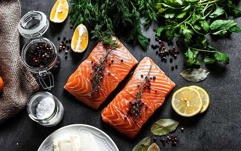 Raw meat with lemon on wood, fish fillet with lemon on wood background