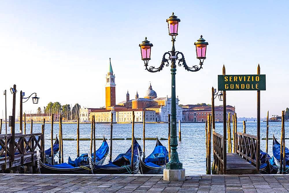 Lantern and parked gondolas at the end of Piazza San Marco with a view of the Basilica of San Giorgio Maggiore, Venice, Veneto, Italy, Europe