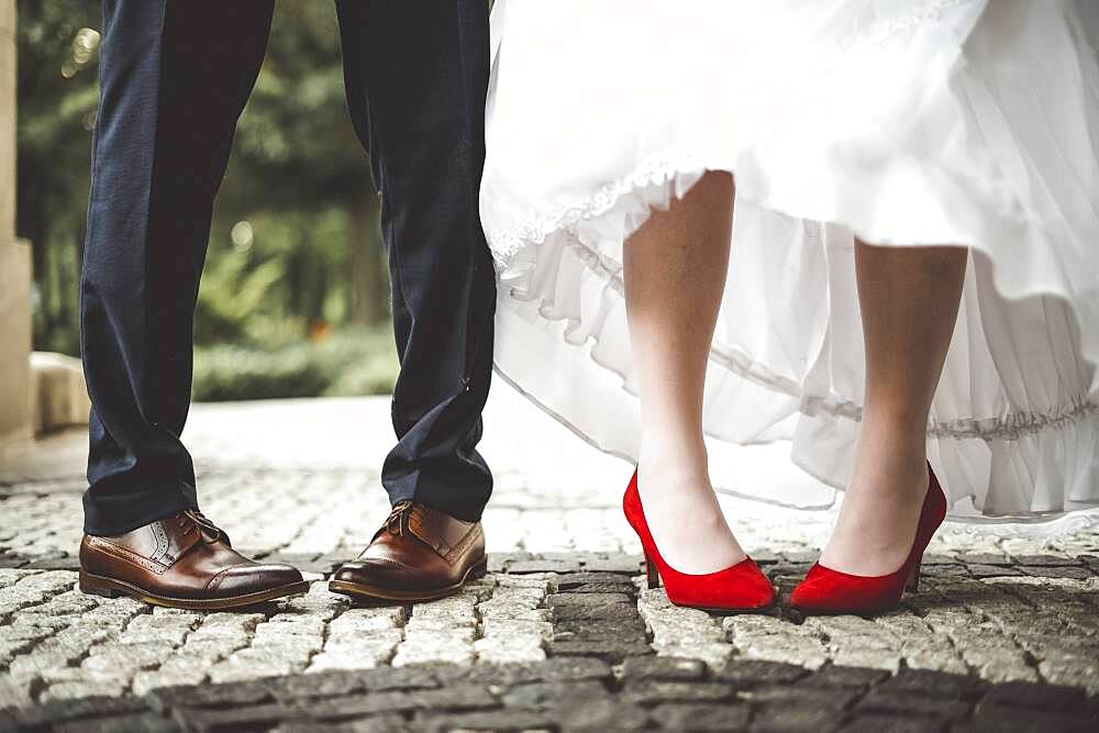 Legs of bride and groom bent inwards. Funny and conceptual