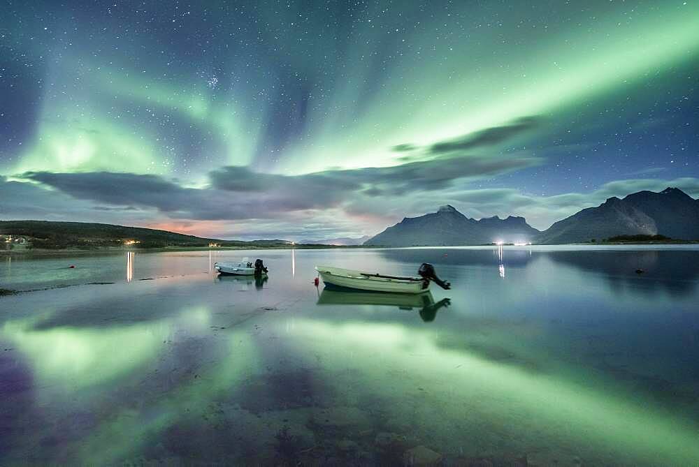 Small (Aurora borealis) motorboats anchoring in a bay, night view, starry sky, northern lights Northern Lights, Straumen, Nordland, Norway, Europe