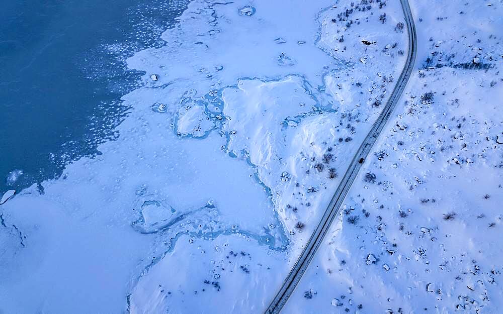 Aerial view, road with single car next to coast at sea, arctic, deep winter landscape, Nordland, Lofoten, Norway, Europe