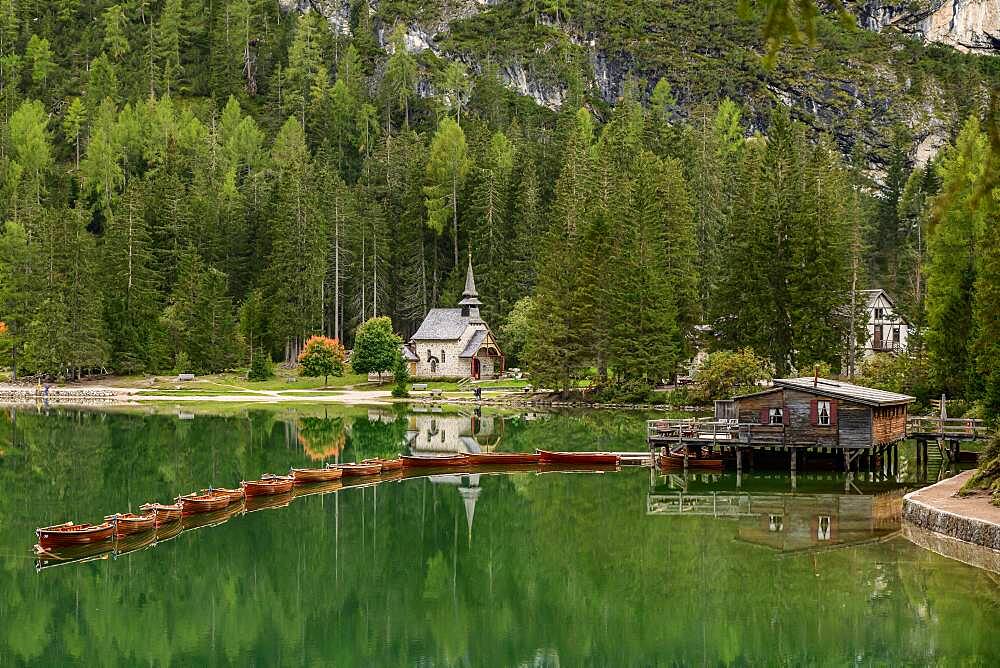 Chapel and boathouse with rowing boats at the Lake Prags Lake, Lago di Lake Prags, Lake Prags Valley, Lake Prags, Dolomites, South Tyrol, Alto Adige, Italy, Europe