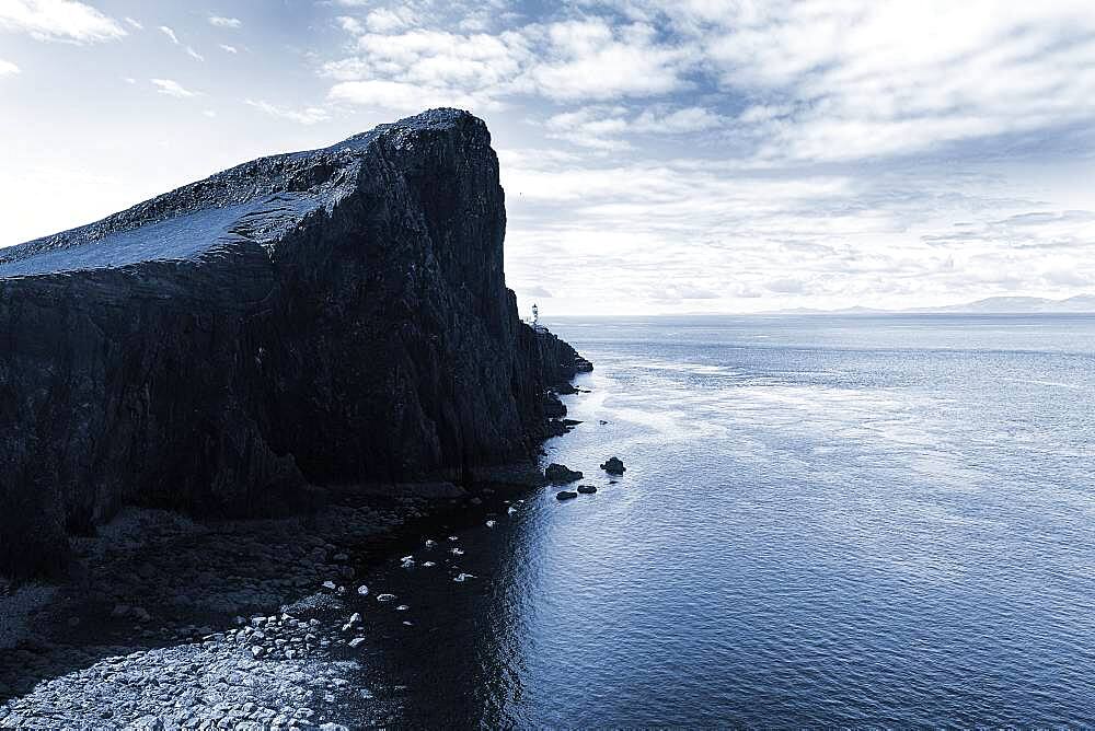 Rocky reef at the North Sea against the light, Neist Point peninsula with lighthouse, Dunvegan, Isle of Sky, Inner Hebrides, Scotland, Great Britain