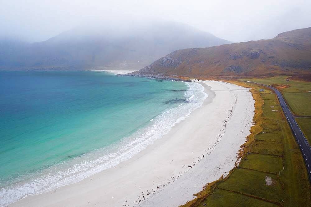 Drone shot, Fine sand beach with turquoise water, camping van in the distance, Haukland beach, Lofoten, Norway, Europe