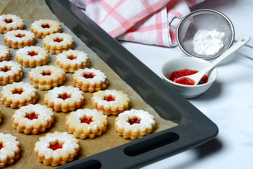 Spitzbube, cookies on baking tray and tray with jelly, Germany, Europe