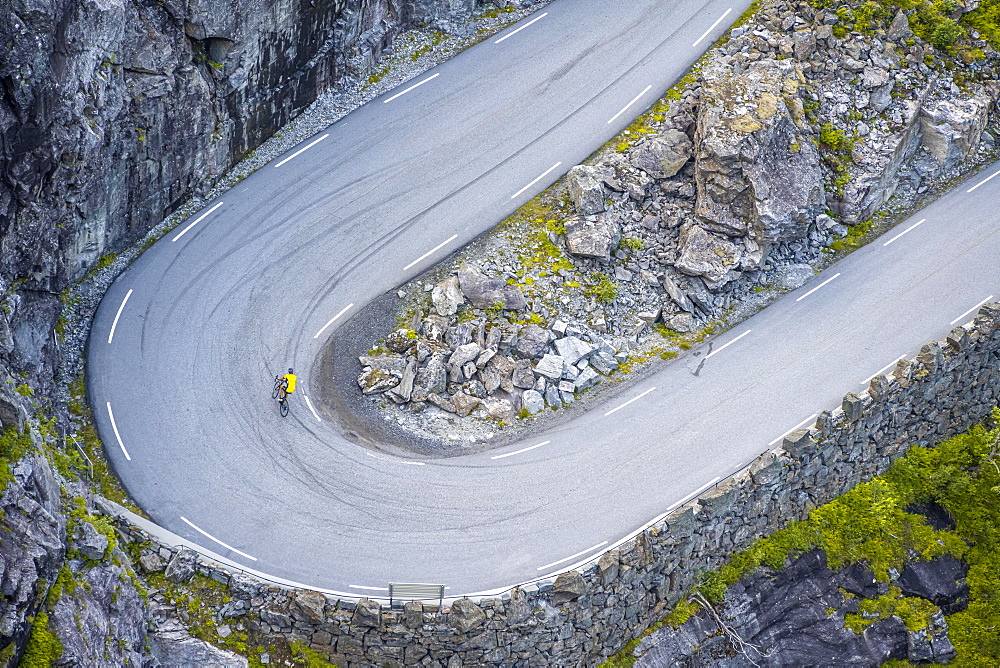 Single cyclist, hairpin bend at the mountain road Trollstigen, near Andalsnes, More og Romsdal, Vestland, Norway, Europe