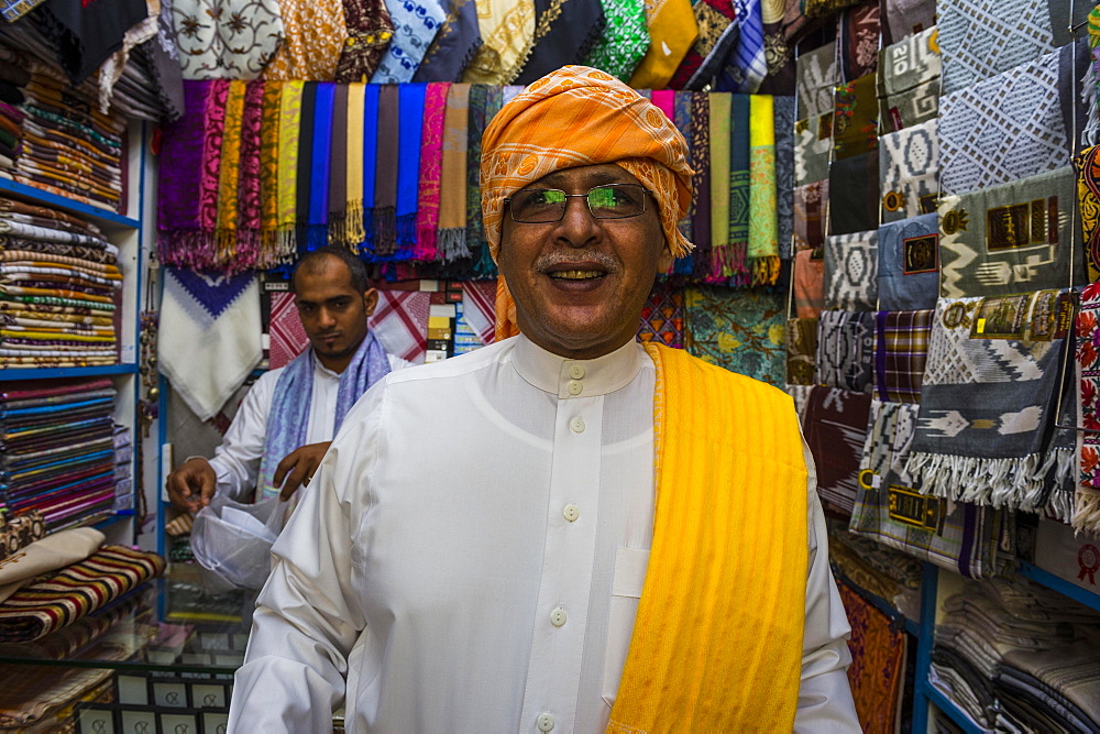 Traditional dressed man in a cloth shop, old town of Jeddah, Saudi Arabia, Asia