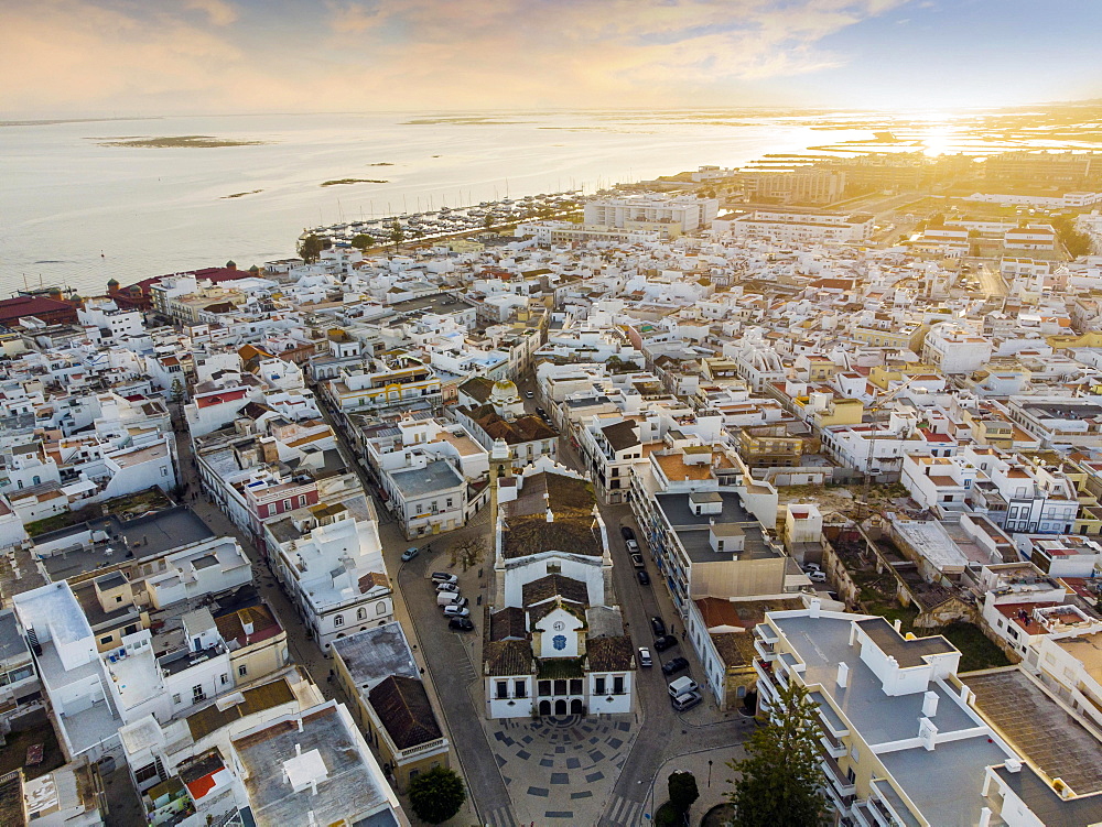 Aerial view of Olhao with a church in the foreground by sunset, Algarve, Portugal, Europe