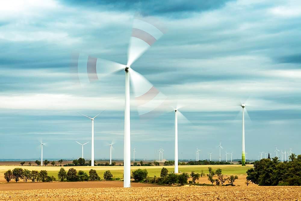 Field landscape with rotating wind turbines, Saalekreis, Saxony-Anhalt, Germany, Europe