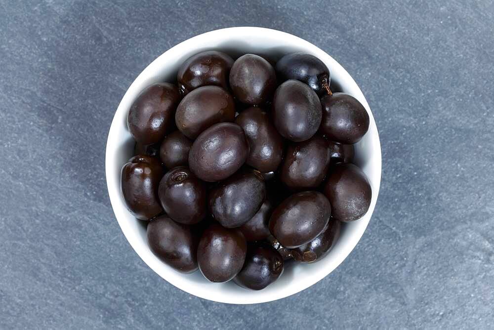 Black olive from above, slate plate, Germany, Europe