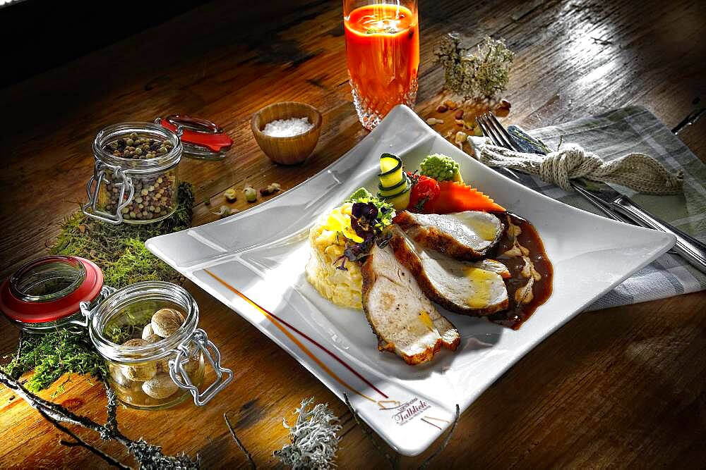 Turkey breast with sauce and risotto, served on a plate