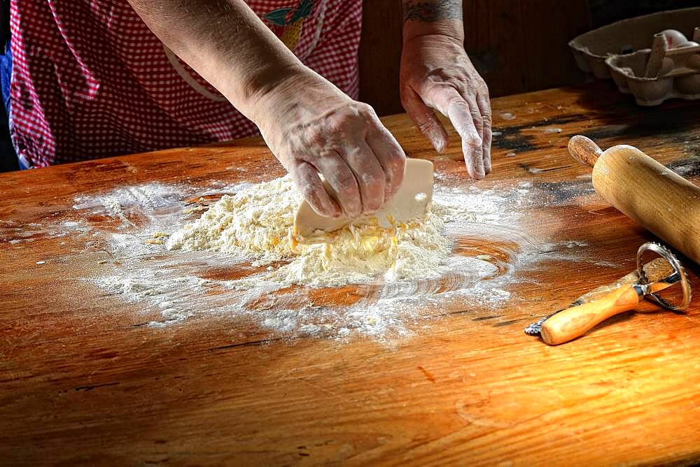 Woman mixes fresh pasta dough, Germany, Europe