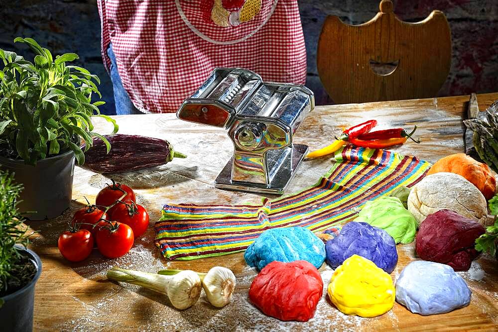 Pasta machine with fresh coloured pasta dough, Germany, Europe