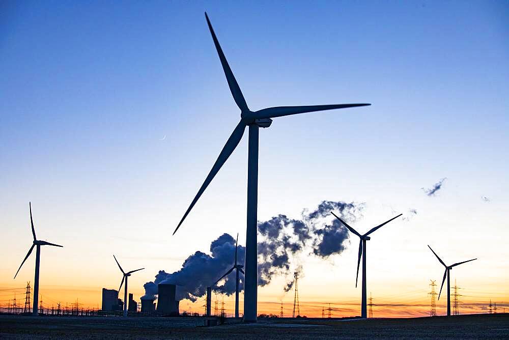 Wind turbines in front of steaming coal-fired power plant at sunset, energy transition, fossil and renewable energy, Niederaussem, North Rhine-Westphalia, Germany, Europe