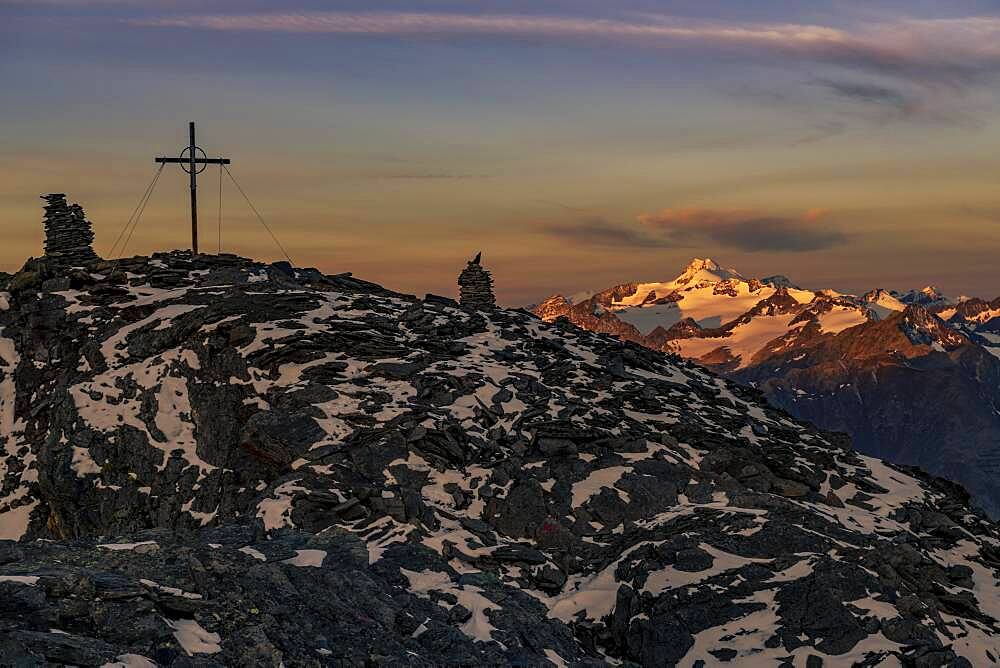 Sunrise over summit of the Oetztaler Wildspitze with summit cross of the high Nebelkogel, Soelden, Oetztal, Tyrol, Austria, Europe