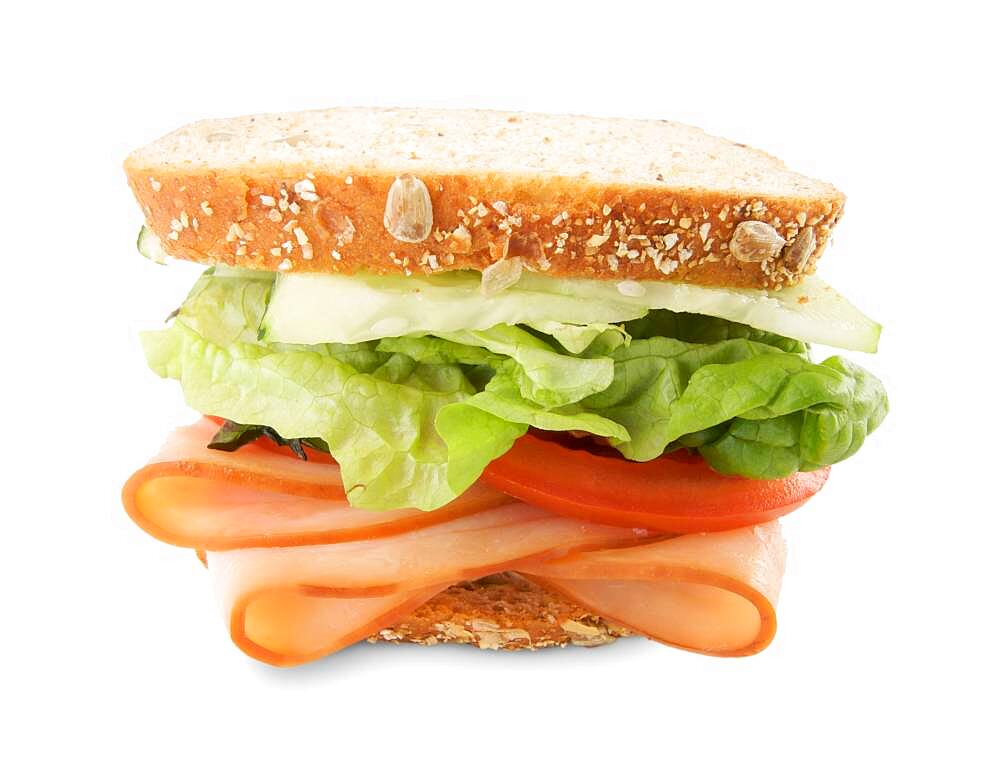 Hearty sandwich filled with vegetables and sliced meat isolated on white