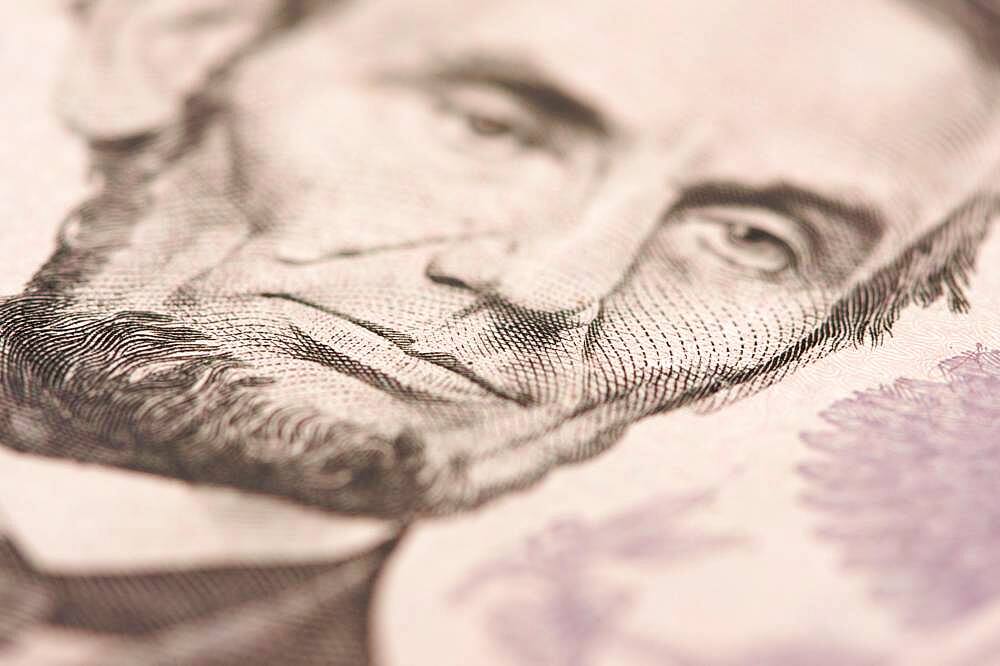 Abstract macro of U.S. five dollar bill's abraham lincoln face with narrow depth of field