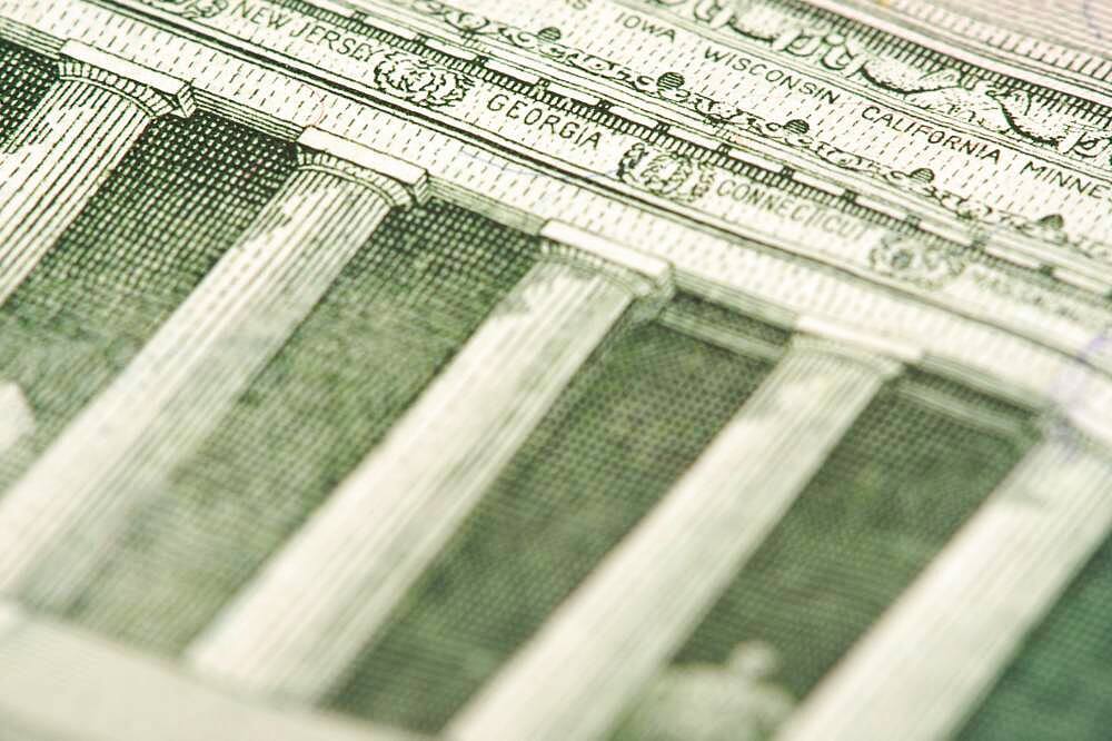 Macro of the back of the U.S. five dollar bill showing small state names as anti-counterfeit measure