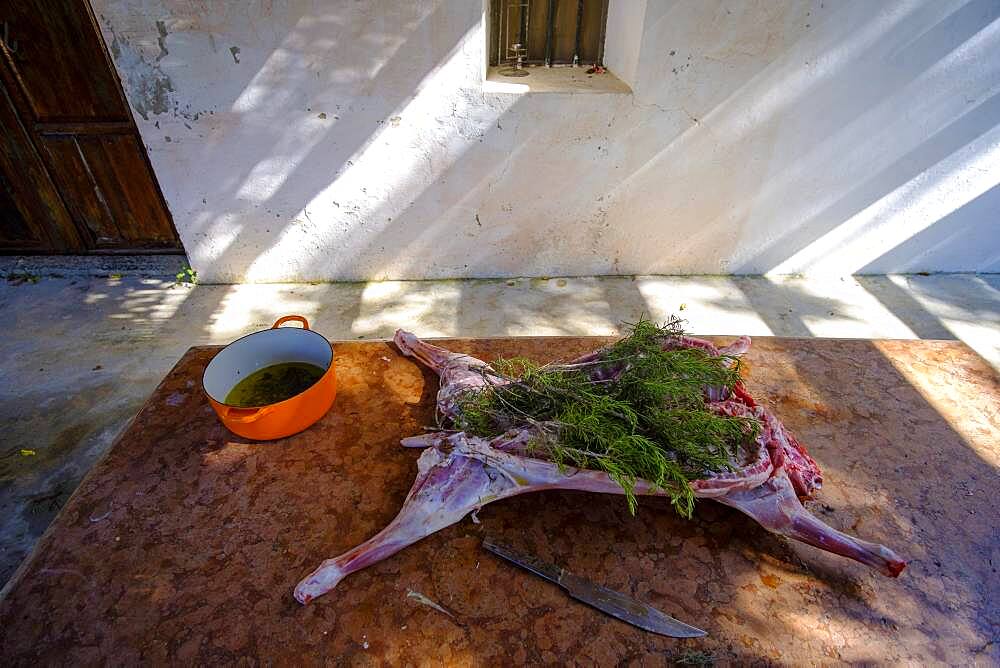 Whole lamb marinating in oil rub and rosemary for asado, in Altea La Vella, Alicante, Spain, Europe