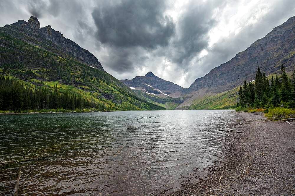 Lake Upper Two Medicine Lake, mountain peaks Lone Walker Mountain and Mount Rockwell in the background, dramatic clouds, Glacier National Park, Montana, USA, North America