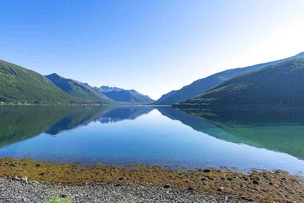 Mountains reflecting in the water, Brensholmen, Senja scenic road, Norway, Europe