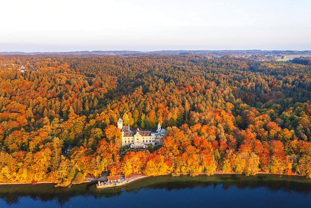 Seeburg Castle at Lake Starnberg in the evening light, near Muensing, autumnal mixed forest, Fuenfseenland, aerial view, Upper Bavaria, Bavaria, Germany, Europe