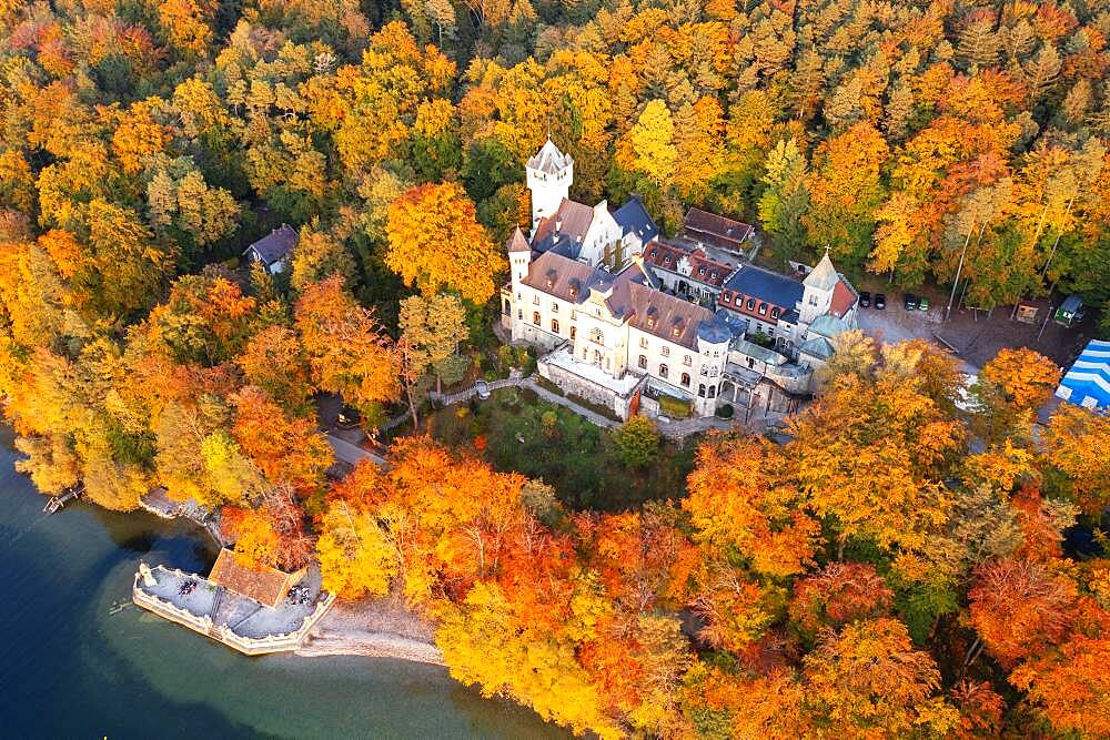 Seeburg Castle at Lake Starnberg in the evening light, near Muensing, autumnal mixed forest, Fuenfseenland, aerial view, Upper Bavaria, Bavaria, Germany, Europe