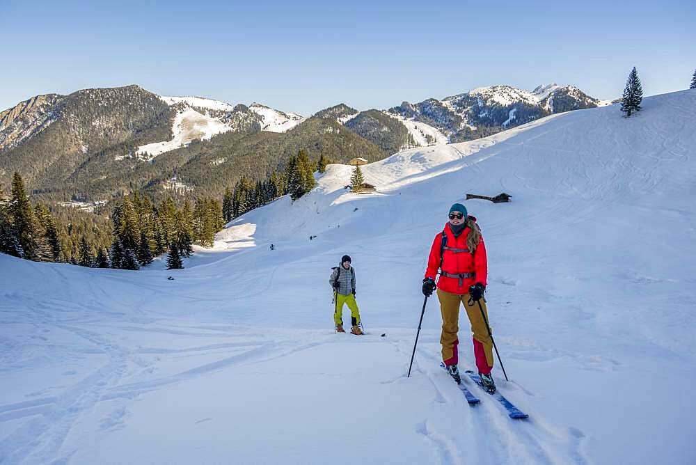 Ski tourers, young woman and man on ski tour to Rosskopf, Mangfall Mountains, Bavarian Prealps, Upper Bavaria, Bavaria, Germany, Europe