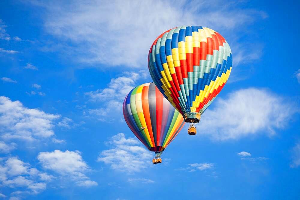 Beautiful hot air balloons against a deep blue sky and clouds