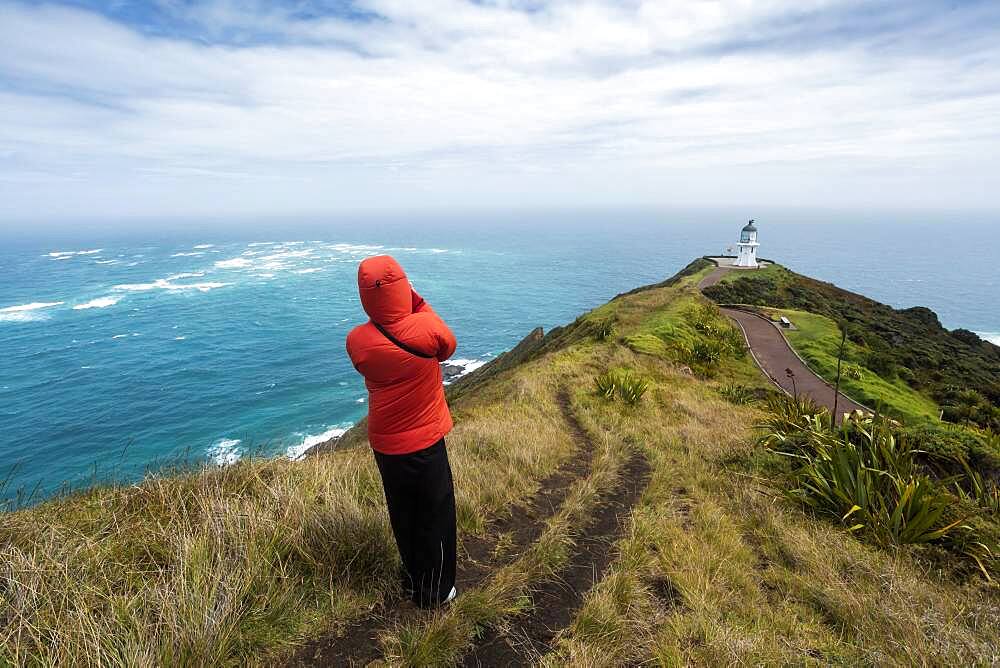 Guy infront of Cape Reinga Lighthouse, Cape Reinga, Te Rerenga Wairua, Northland, North Island, New Zealand, Oceania